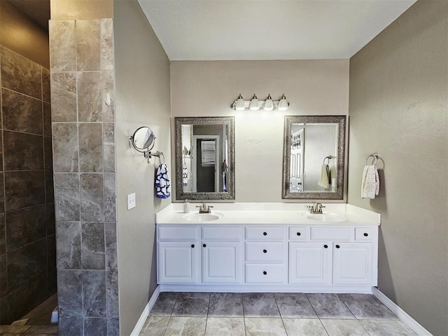12401 SW 7th St, Yukon, OK 73099 - bathroom featuring double vanity, baseboards, and a walk in shower