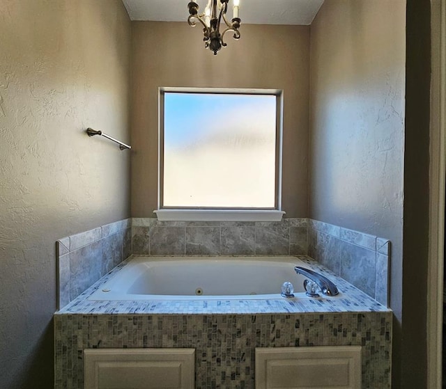 12401 SW 7th St, Yukon, OK 73099 - bathroom with a chandelier and a jetted tub