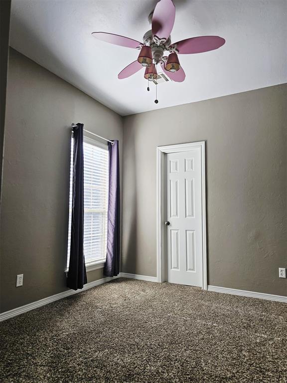 12401 SW 7th St, Yukon, OK 73099 - unfurnished room featuring a ceiling fan, carpet flooring, and baseboards