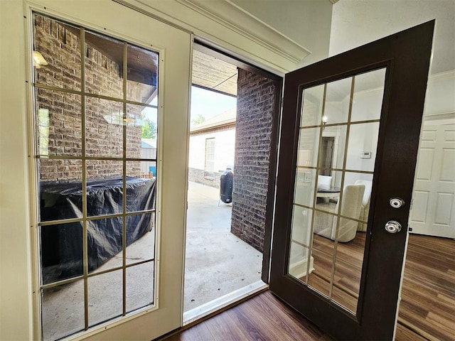 12401 SW 7th St, Yukon, OK 73099 - doorway with dark wood-type flooring and brick wall