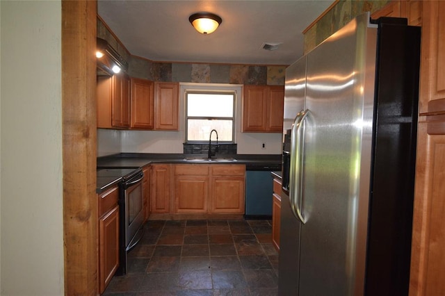 3708 NW 59th St, Oklahoma City, OK 73112 - kitchen featuring stainless steel appliances, a sink, dark countertops, dark stone finish floors, and brown cabinetry