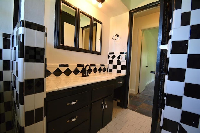 3708 NW 59th St, Oklahoma City, OK 73112 - bathroom with decorative backsplash, stone finish flooring, and vanity