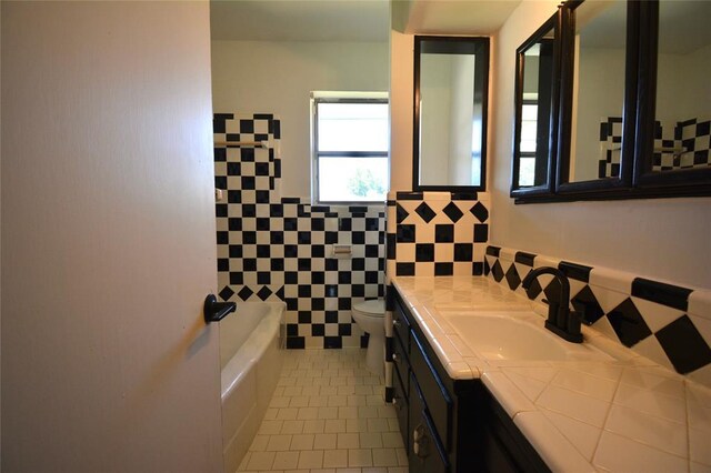 3708 NW 59th St, Oklahoma City, OK 73112 - full bath with tile patterned flooring, tile walls, toilet, a bath, and vanity