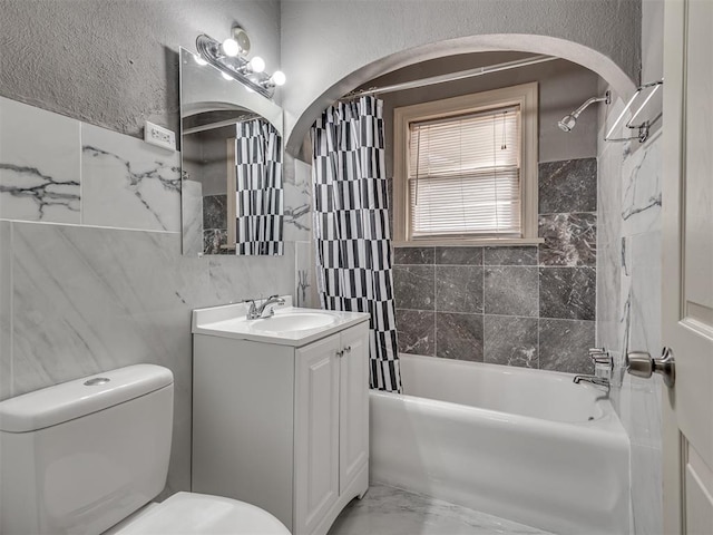 2617 NW 23rd St, Oklahoma City, OK 73107 - bathroom featuring toilet, shower / bathtub combination with curtain, tile walls, and vanity