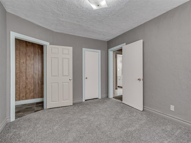 2617 NW 23rd St, Oklahoma City, OK 73107 - unfurnished bedroom featuring a textured ceiling, baseboards, and carpet