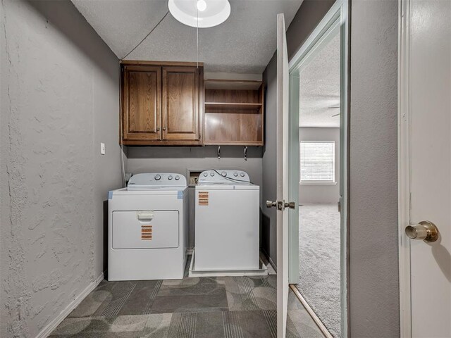2617 NW 23rd St, Oklahoma City, OK 73107 - laundry area with cabinet space, separate washer and dryer, a textured ceiling, dark colored carpet, and a textured wall