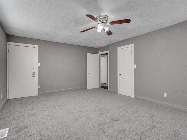 2617 NW 23rd St, Oklahoma City, OK 73107 - unfurnished bedroom with a textured ceiling, carpet flooring, and a ceiling fan