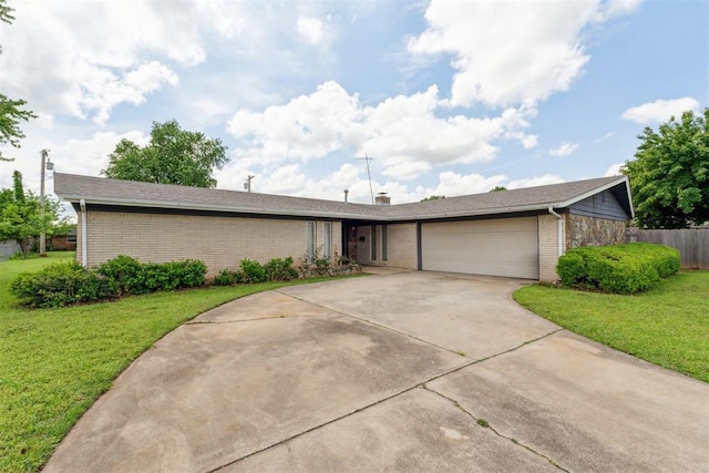 1009 Cherokee Pl, Lindsay, OK 73052 - view of front of property featuring brick siding, an attached garage, and driveway