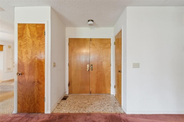 1009 Cherokee Pl, Lindsay, OK 73052 - corridor with baseboards, a textured ceiling, and carpet