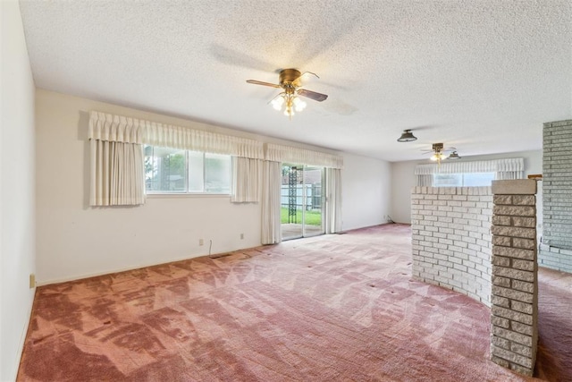 1009 Cherokee Pl, Lindsay, OK 73052 - unfurnished living room with a ceiling fan, carpet flooring, plenty of natural light, and a textured ceiling