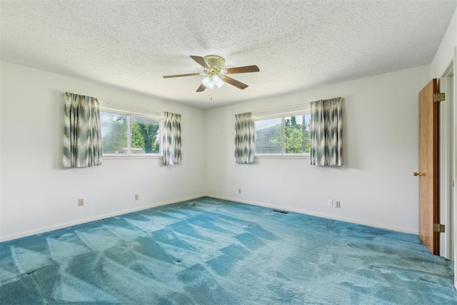 1009 Cherokee Pl, Lindsay, OK 73052 - empty room with a ceiling fan, healthy amount of natural light, carpet, and a textured ceiling