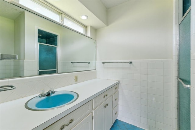 1009 Cherokee Pl, Lindsay, OK 73052 - full bath with tile walls, vanity, a shower stall, a wainscoted wall, and recessed lighting