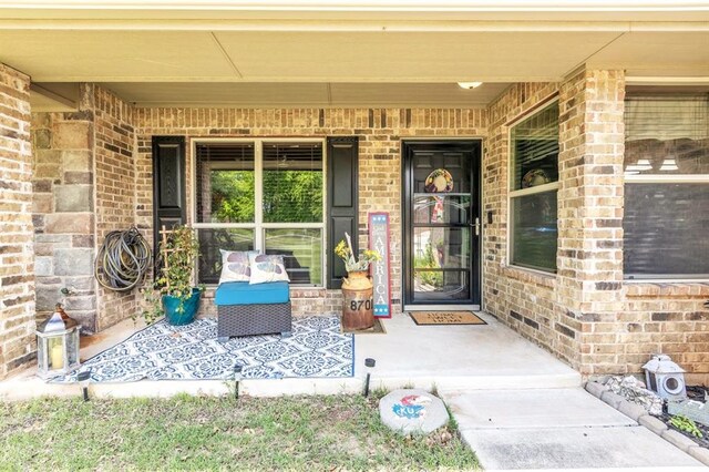 8701 Long Spur Trl, Edmond, OK 73034 - property entrance featuring brick siding and covered porch