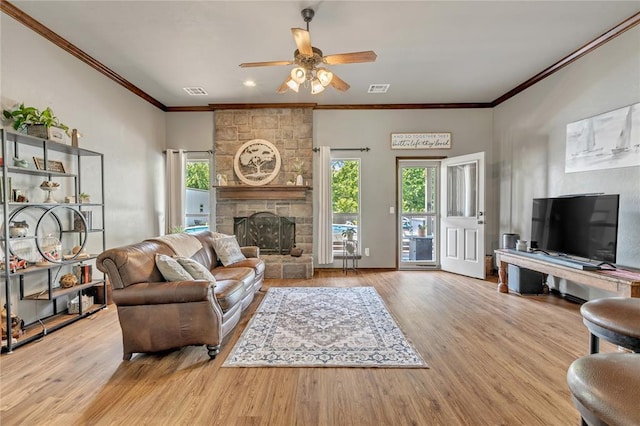 8701 Long Spur Trl, Edmond, OK 73034 - living area featuring a ceiling fan, ornamental molding, wood finished floors, and a fireplace