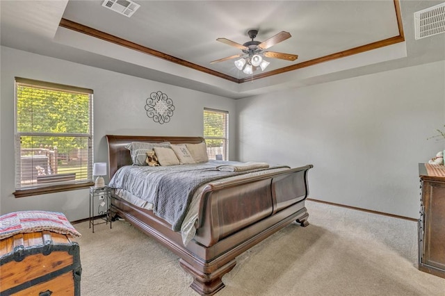 8701 Long Spur Trl, Edmond, OK 73034 - bedroom with a tray ceiling, baseboards, carpet floors, and crown molding