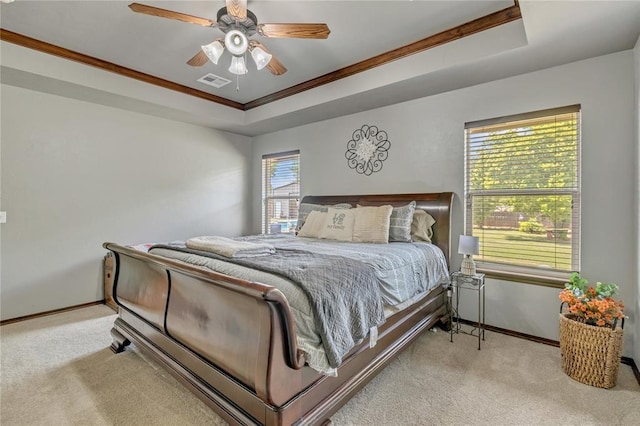 8701 Long Spur Trl, Edmond, OK 73034 - bedroom with carpet flooring, a tray ceiling, ornamental molding, baseboards, and ceiling fan