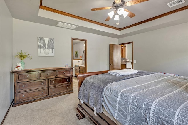 8701 Long Spur Trl, Edmond, OK 73034 - bedroom featuring a tray ceiling, light colored carpet, crown molding, ensuite bath, and ceiling fan