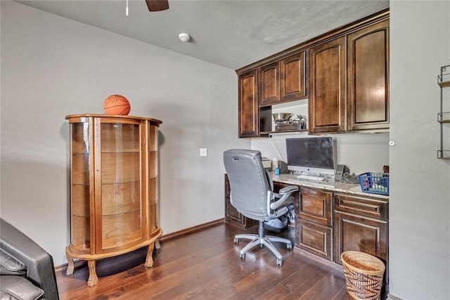 8701 Long Spur Trl, Edmond, OK 73034 - office area featuring dark wood-type flooring, ceiling fan, built in desk, and baseboards