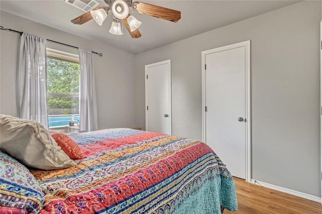 8701 Long Spur Trl, Edmond, OK 73034 - bedroom with light wood-type flooring, baseboards, and ceiling fan