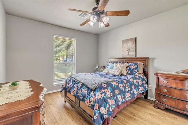 8701 Long Spur Trl, Edmond, OK 73034 - bedroom featuring wood finished floors, baseboards, and a ceiling fan