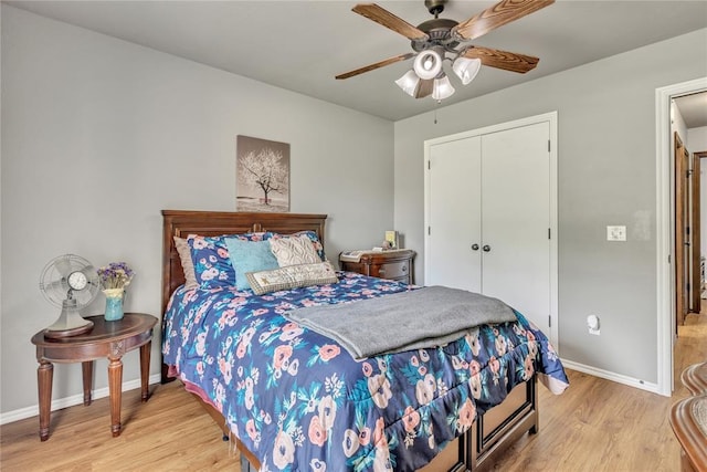 8701 Long Spur Trl, Edmond, OK 73034 - bedroom with light wood finished floors, baseboards, a closet, and a ceiling fan