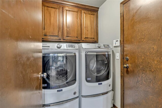 8701 Long Spur Trl, Edmond, OK 73034 - clothes washing area featuring washer and clothes dryer and cabinet space