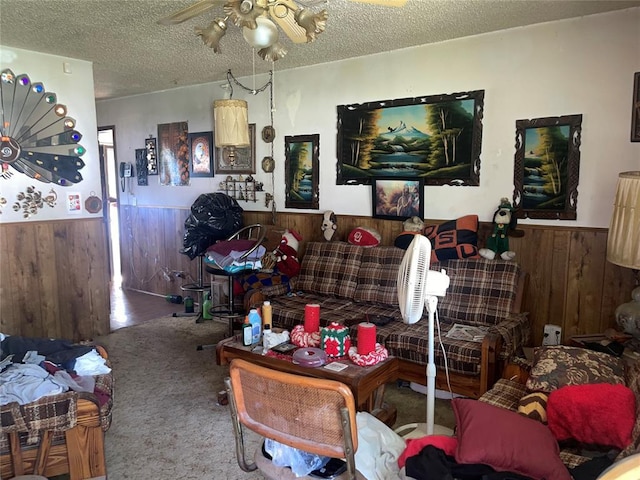 811 N Admire Ave, El Reno, OK 73036 - living area featuring wainscoting, wood walls, ceiling fan, a textured ceiling, and carpet