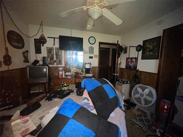 811 N Admire Ave, El Reno, OK 73036 - living room with wainscoting, a ceiling fan, and wood walls