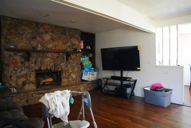 4753 SE 17th St, Oklahoma City, OK 73115 - living area featuring wood finished floors, a fireplace, and a textured ceiling