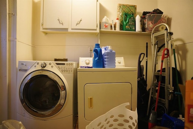 4753 SE 17th St, Oklahoma City, OK 73115 - clothes washing area featuring washing machine and clothes dryer and cabinet space