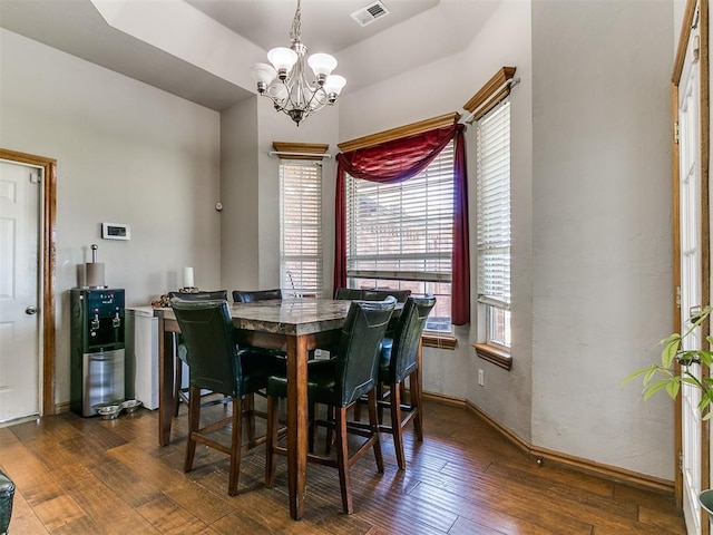 9315 Fendrych Dr, Oklahoma City, OK 73165 - dining room featuring a chandelier, dark wood-style flooring, and baseboards