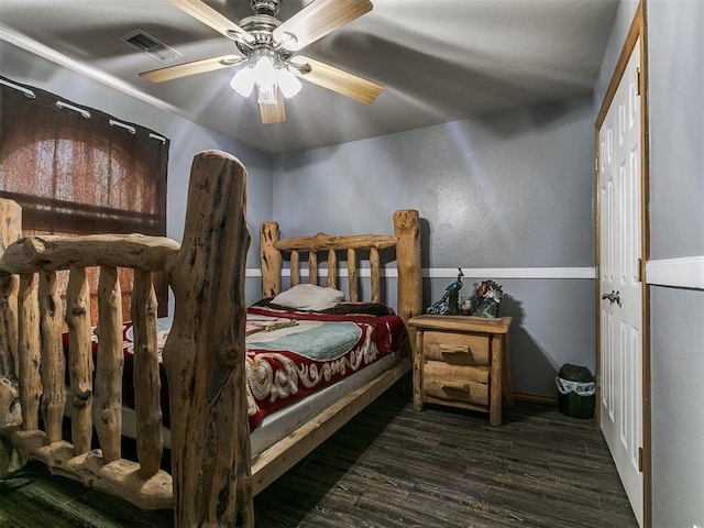 9315 Fendrych Dr, Oklahoma City, OK 73165 - bedroom featuring wood finished floors, a ceiling fan, baseboards, and a textured wall