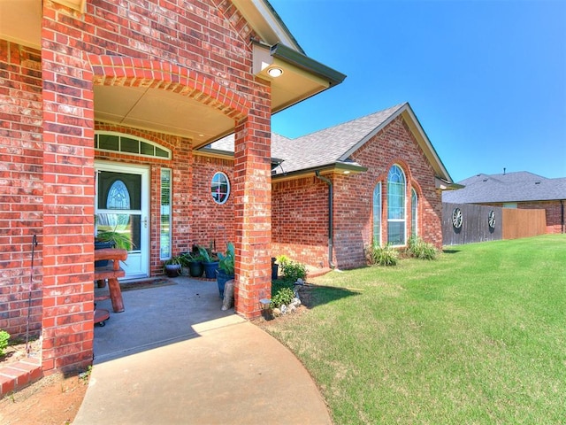 9315 Fendrych Dr, Oklahoma City, OK 73165 - property entrance featuring brick siding, a lawn, and a shingled roof