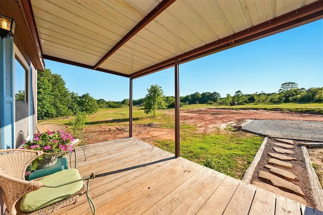 wooden deck with view of scattered trees