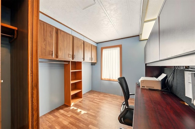 office featuring light wood-style floors and a textured ceiling