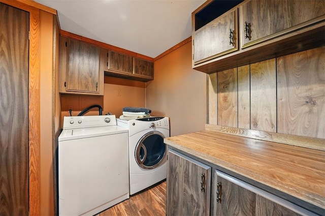 laundry area with cabinet space, separate washer and dryer, and dark wood-style flooring