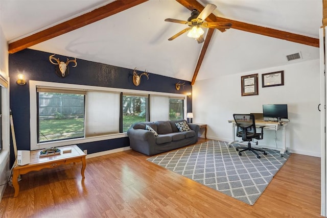 living room featuring beamed ceiling, a ceiling fan, wood finished floors, an office area, and baseboards
