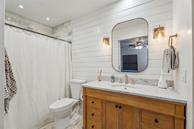 full bath featuring toilet, wood walls, ceiling fan, vanity, and curtained shower
