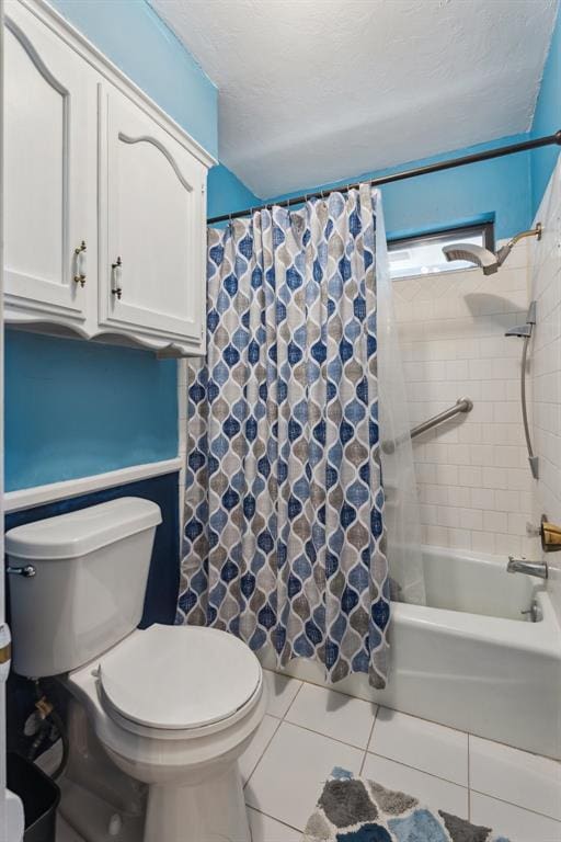 bathroom with tile patterned floors, toilet, and shower / tub combo with curtain