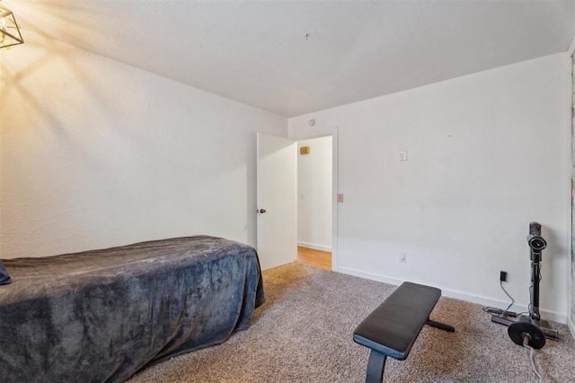 bedroom with carpet flooring and baseboards
