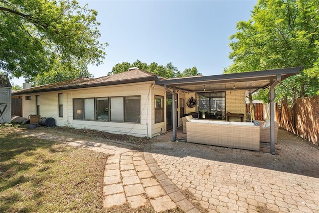 rear view of property with a patio area, fence, brick siding, and an outdoor hangout area