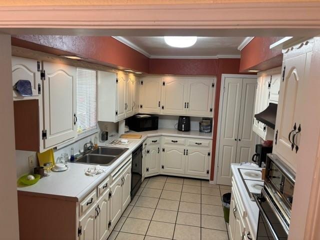 405 W Choctaw St, Lindsay, OK 73052 - kitchen featuring black appliances, light tile patterned flooring, white cabinets, a sink, and light countertops