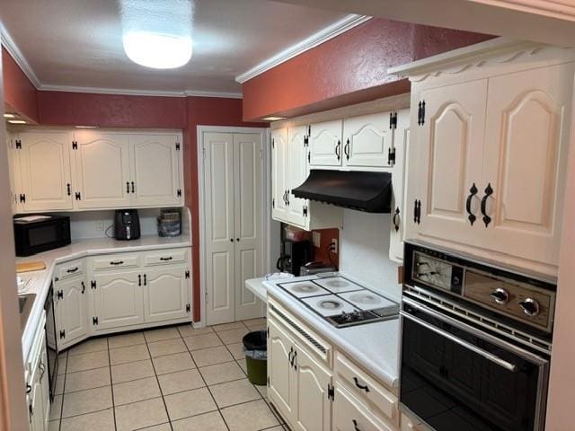 405 W Choctaw St, Lindsay, OK 73052 - kitchen featuring black appliances, under cabinet range hood, crown molding, white cabinetry, and light countertops