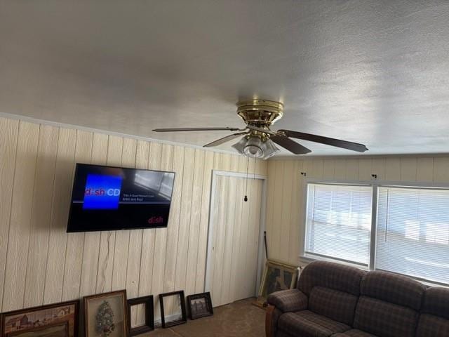 405 W Choctaw St, Lindsay, OK 73052 - living room with ceiling fan and wooden walls