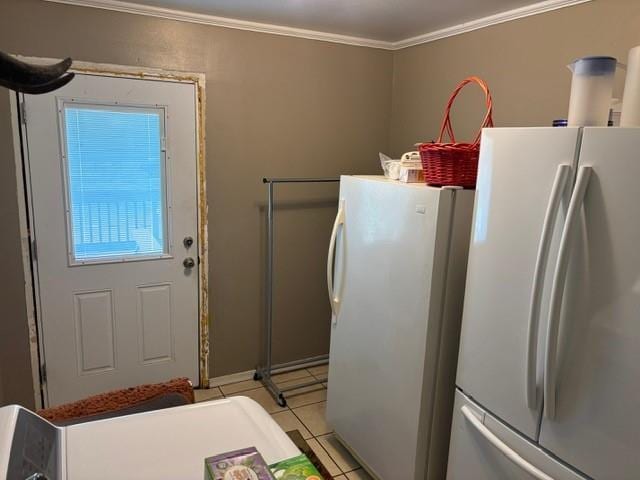 405 W Choctaw St, Lindsay, OK 73052 - laundry area with crown molding and light tile patterned floors