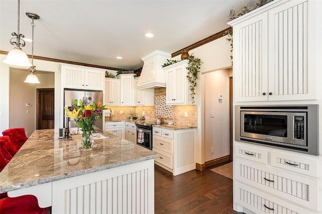 kitchen with appliances with stainless steel finishes, dark wood-style floors, decorative backsplash, light stone counters, and custom range hood