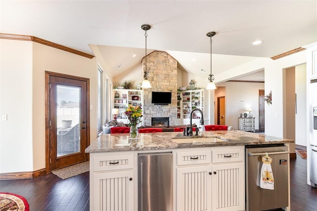 kitchen featuring a sink, dark wood-type flooring, open floor plan, vaulted ceiling, and white cabinets