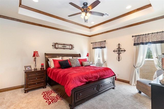 bedroom with a tray ceiling, light colored carpet, baseboards, ornamental molding, and recessed lighting
