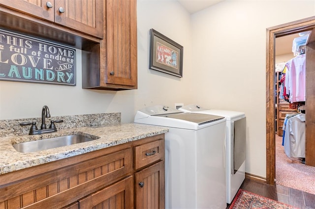 washroom featuring washer and dryer, cabinet space, and dark wood finished floors