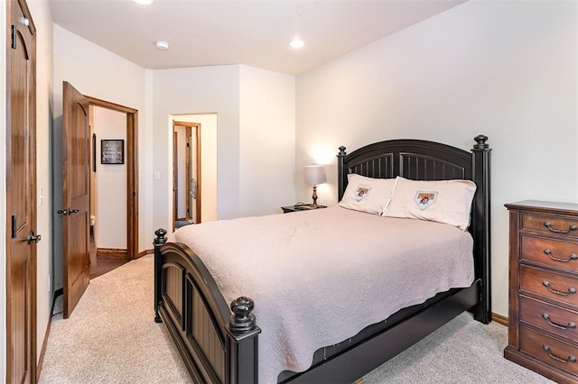 carpeted bedroom featuring baseboards and recessed lighting